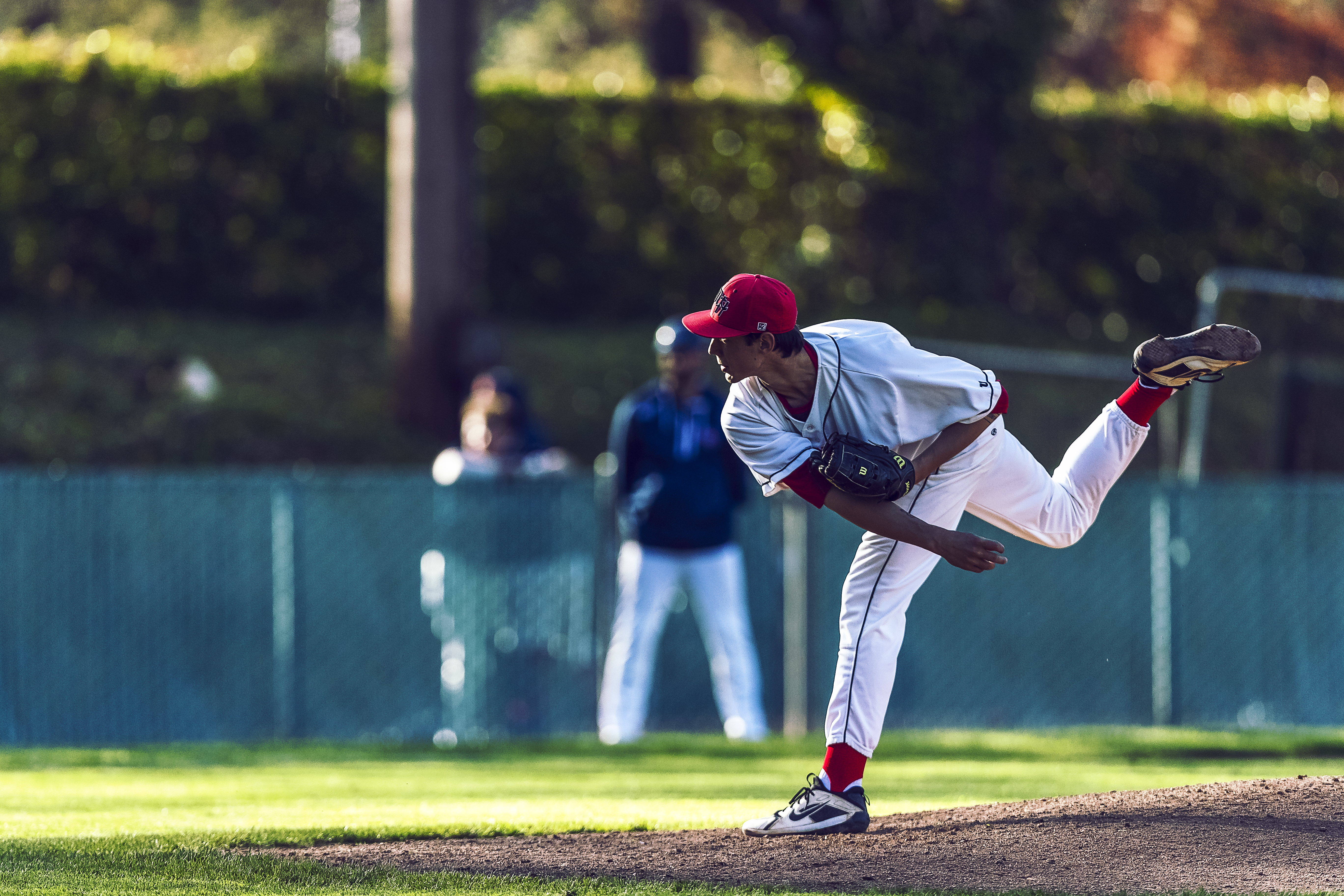 Saints player pitching baseball