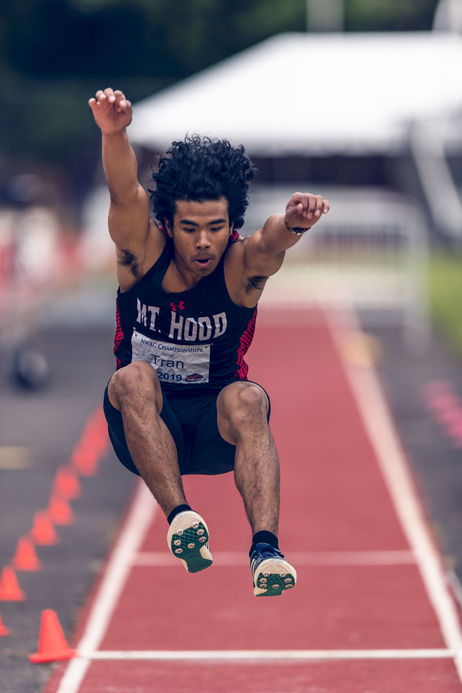 Long Jumper Willie Tran prepares to land on the sand